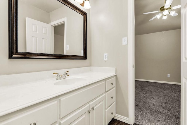 5909 Woodwind Dr, Plano, TX 75093 - bathroom with vanity, baseboards, and a ceiling fan