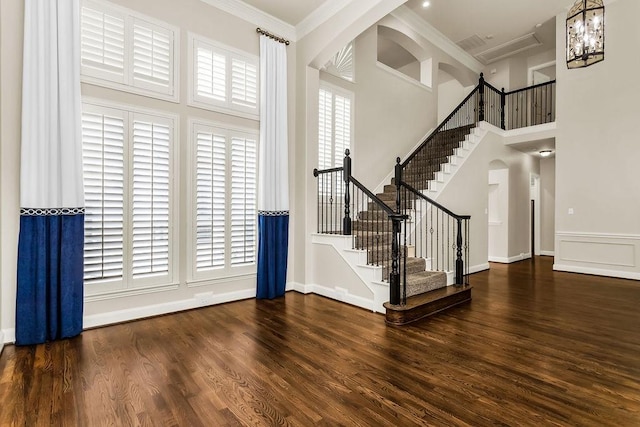 5909 Woodwind Dr, Plano, TX 75093 - entryway featuring wood finished floors, ornamental molding, stairs, and a high ceiling