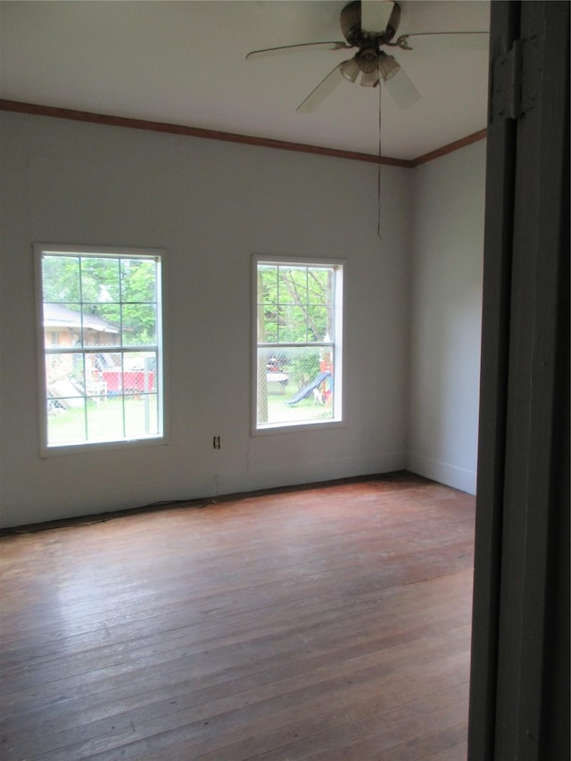 1203 Sewanee Dr, Marlin, TX 76661 - unfurnished room with crown molding, healthy amount of natural light, wood finished floors, ceiling fan, and baseboards