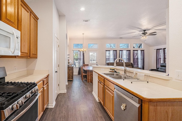 813 Royal Oak Ln, Burleson, TX 76028 - kitchen with appliances with stainless steel finishes, a sink, dark wood-type flooring, light countertops, and a chandelier