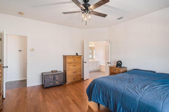 813 Royal Oak Ln, Burleson, TX 76028 - bedroom featuring wood finished floors, baseboards, ensuite bathroom, and a ceiling fan
