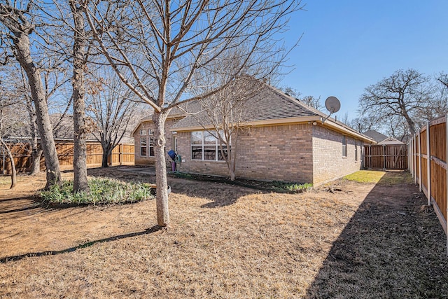813 Royal Oak Ln, Burleson, TX 76028 - back of house with brick siding, a fenced backyard, and a shingled roof