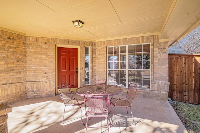 813 Royal Oak Ln, Burleson, TX 76028 - doorway to property featuring outdoor dining area, a patio, and brick siding