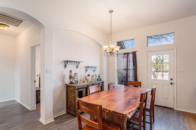 813 Royal Oak Ln, Burleson, TX 76028 - dining area with arched walkways, a chandelier, dark wood-style flooring, and baseboards