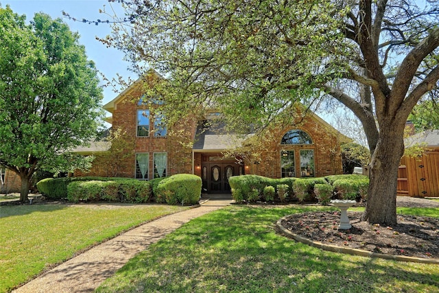 3908 Jamestown Pl, Plano, TX 75023 - traditional home with brick siding, a front yard, and a shingled roof