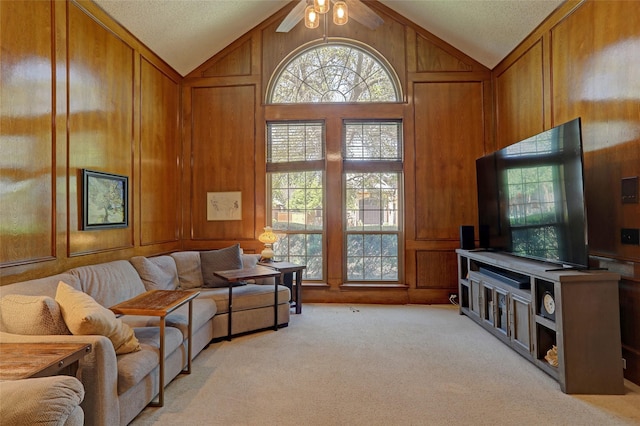3908 Jamestown Pl, Plano, TX 75023 - living area featuring vaulted ceiling, light colored carpet, ceiling fan, and wooden walls