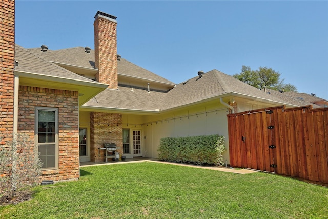 3908 Jamestown Pl, Plano, TX 75023 - rear view of house with a shingled roof, brick siding, and a chimney