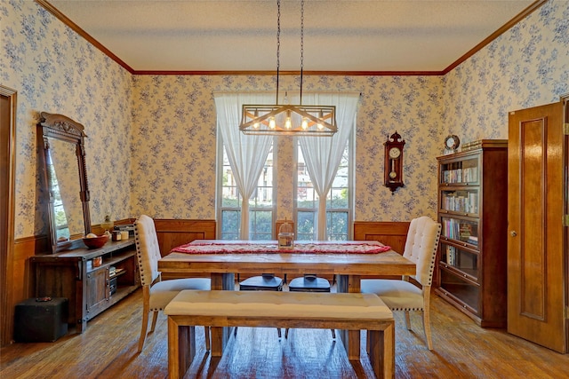 3908 Jamestown Pl, Plano, TX 75023 - dining area featuring hardwood / wood-style flooring, wainscoting, wallpapered walls, crown molding, and a chandelier