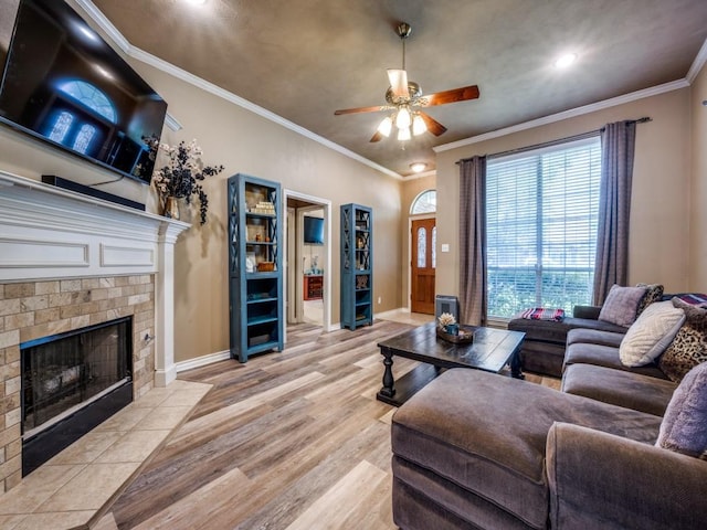 320 Willow Stone St, Denton, TX 76207 - living area with a fireplace, ceiling fan, light wood-type flooring, baseboards, and ornamental molding