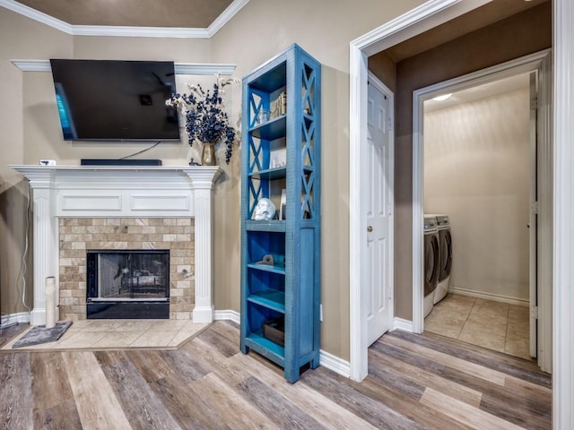 320 Willow Stone St, Denton, TX 76207 - unfurnished living room with washer and dryer, wood finished floors, crown molding, a fireplace, and baseboards