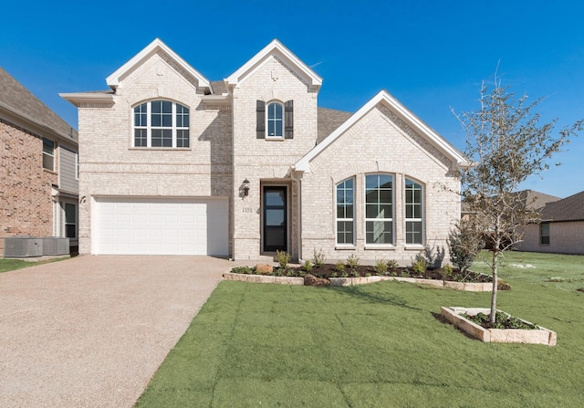 1323 Sundance Ln, Justin, TX 76247 - french country home featuring concrete driveway, brick siding, a front yard, a garage, and central AC unit