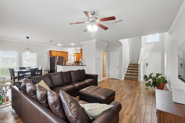 1900 Cassandra Ct, Fort Worth, TX 76131 - living room featuring stairs, ceiling fan, crown molding, arched walkways, and wood finished floors