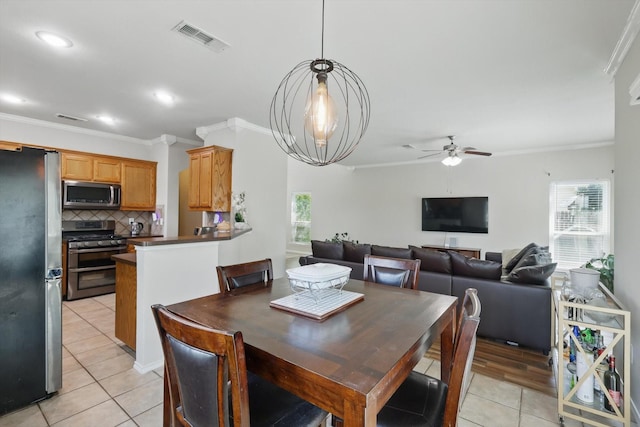 1900 Cassandra Ct, Fort Worth, TX 76131 - dining area with light tile patterned floors, plenty of natural light, ceiling fan, crown molding, and recessed lighting