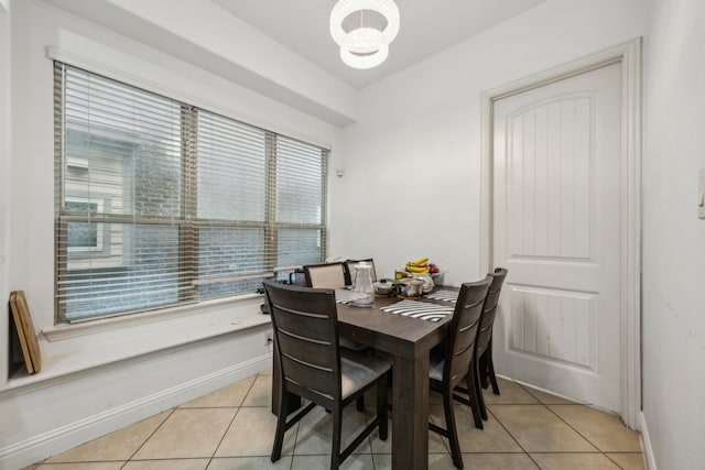5005 Dominion Blvd, Irving, TX 75038 - dining space with light tile patterned floors, a chandelier, and baseboards