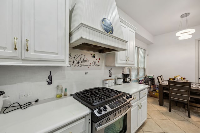 5005 Dominion Blvd, Irving, TX 75038 - kitchen featuring gas range, white cabinets, premium range hood, light tile patterned flooring, and light countertops