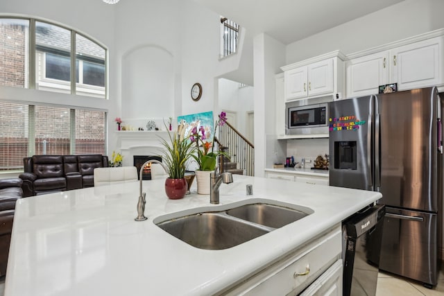5005 Dominion Blvd, Irving, TX 75038 - kitchen with appliances with stainless steel finishes, a high ceiling, light countertops, white cabinets, and open floor plan