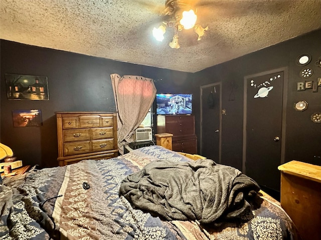 903 College St, Sulphur Springs, TX 75482 - bedroom featuring a textured ceiling, cooling unit, and ceiling fan