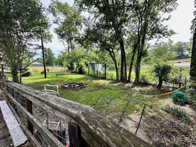 903 College St, Sulphur Springs, TX 75482 - view of grassy yard featuring an outdoor fire pit