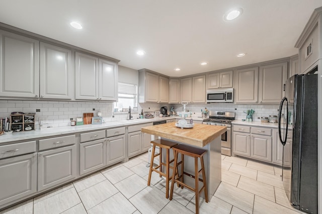 300 E Shoemaker St, Decatur, TX 76234 - kitchen with appliances with stainless steel finishes, gray cabinetry, a sink, and recessed lighting