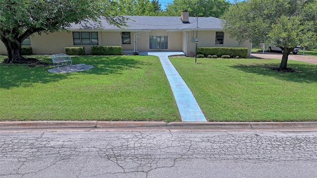 1106 Central Ave, Bowie, TX 76230 - view of front of property with a front lawn, brick siding, and a chimney