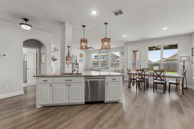 1042 Watercourse Pl, Royse City, TX 75189 - kitchen with dishwasher, a sink, baseboards, arched walkways, and white cabinetry