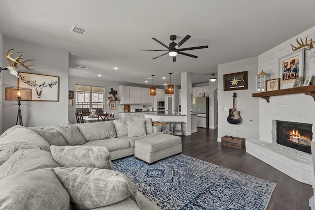 1042 Watercourse Pl, Royse City, TX 75189 - living area with a ceiling fan, dark wood finished floors, a stone fireplace, and recessed lighting