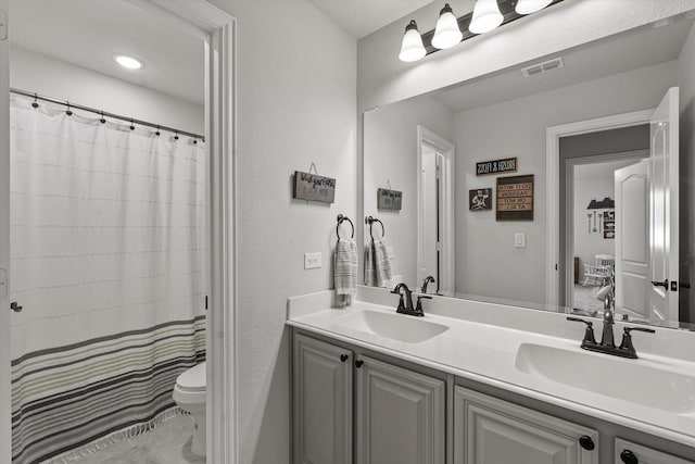 1042 Watercourse Pl, Royse City, TX 75189 - bathroom featuring toilet, double vanity, curtained shower, and tile patterned floors