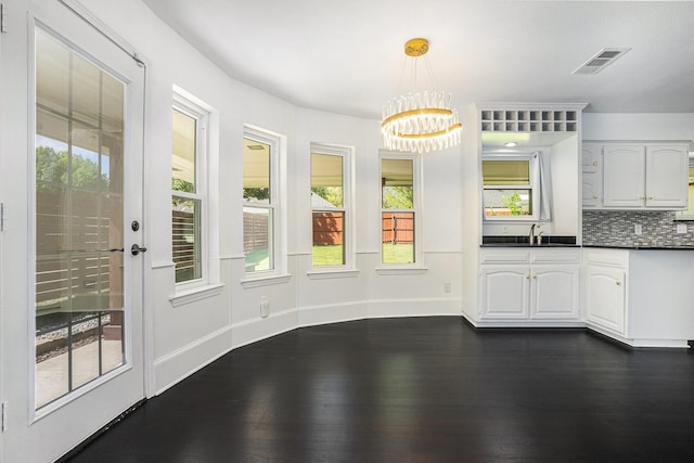 9112 Westwood Shores Dr, Fort Worth, TX 76179 - unfurnished dining area with a chandelier, dark wood-style floors, baseboards, and a sink