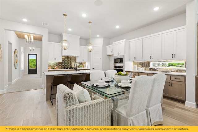 1044 Olympic Dr, Rockwall, TX 75087 - dining area with light wood-type flooring, recessed lighting, and baseboards