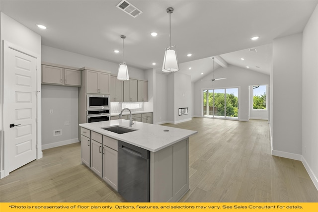 1044 Olympic Dr, Rockwall, TX 75087 - kitchen with a sink, stainless steel appliances, gray cabinetry, baseboards, and recessed lighting