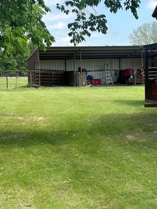 285 NE 5th St, Bogata, TX 75417 - view of yard featuring a pole building, an outdoor structure, and a carport