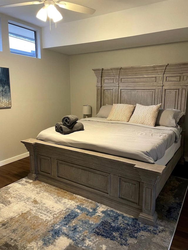 2301 Newcastle Cir, Plano, TX 75075 - bedroom with baseboards, dark wood-style floors, and a ceiling fan
