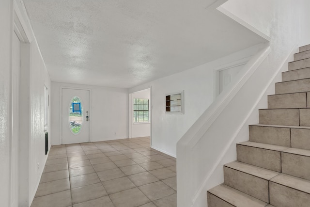 84 Natchez Rd, Pottsboro, TX 75076 - foyer entrance with stairs, a textured ceiling, and light tile patterned floors
