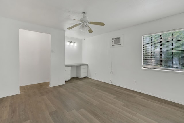 84 Natchez Rd, Pottsboro, TX 75076 - unfurnished room featuring wood finished floors, ceiling fan, a wall mounted air conditioner, and baseboards