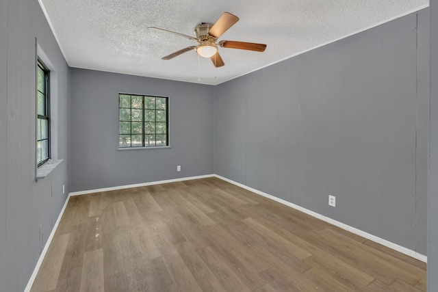 84 Natchez Rd, Pottsboro, TX 75076 - empty room featuring a textured ceiling, wood finished floors, a ceiling fan, and baseboards