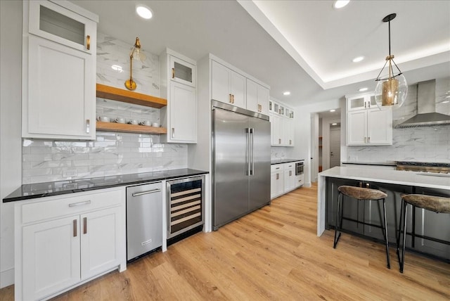 3417 Dovehill Dr, Northlake, TX 76247 - kitchen with stainless steel appliances, beverage cooler, wall chimney exhaust hood, backsplash, and recessed lighting