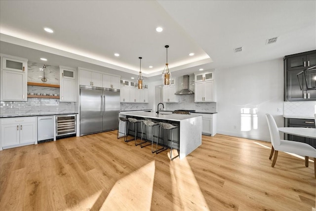 3417 Dovehill Dr, Northlake, TX 76247 - kitchen with wall chimney exhaust hood, built in fridge, wine cooler, backsplash, and a sink