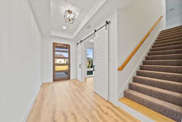 3417 Dovehill Dr, Northlake, TX 76247 - foyer with a barn door, light wood-style flooring, stairway, and baseboards