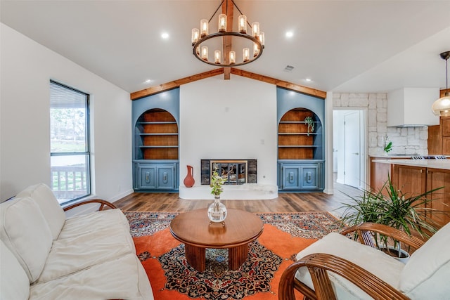 130 Holland Dr, Denison, TX 75020 - living area featuring built in shelves, lofted ceiling, wood finished floors, a chandelier, and baseboards