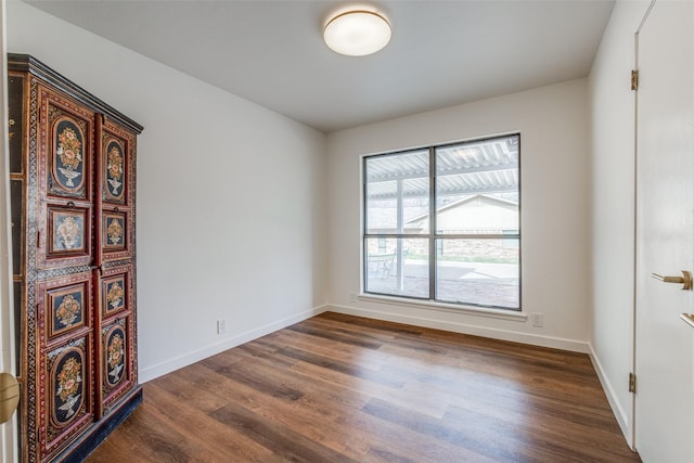 130 Holland Dr, Denison, TX 75020 - empty room featuring dark wood-style floors and baseboards