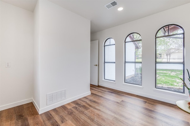 130 Holland Dr, Denison, TX 75020 - empty room featuring wood finished floors, baseboards, and recessed lighting