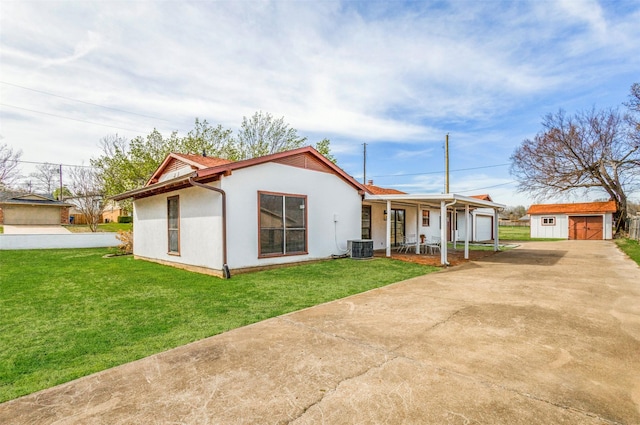 130 Holland Dr, Denison, TX 75020 - view of front of house featuring covered porch, a front lawn, an outbuilding, and stucco siding