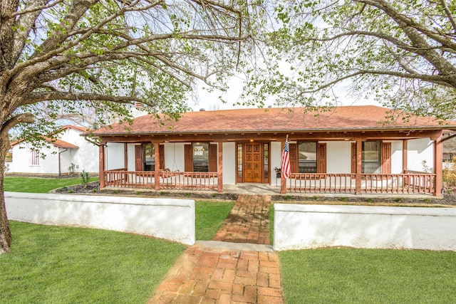 130 Holland Dr, Denison, TX 75020 - ranch-style home with a porch and a front lawn