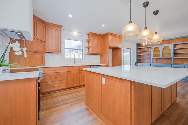 130 Holland Dr, Denison, TX 75020 - kitchen with open shelves, stainless steel appliances, decorative backsplash, light wood-type flooring, and light countertops