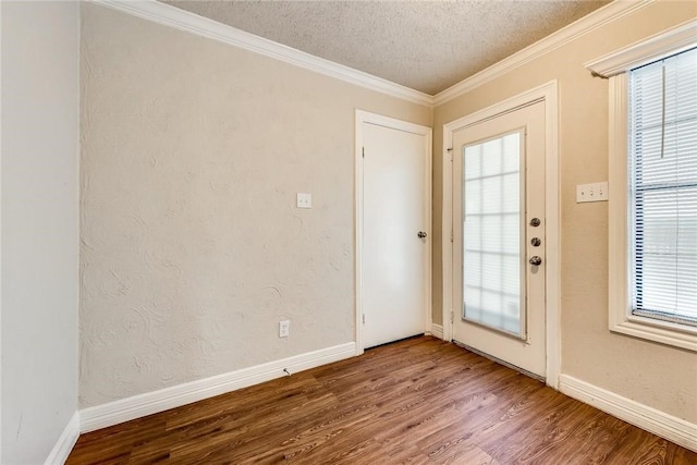 3610 Peakview Dr, Corinth, TX 76210 - entryway featuring wood finished floors, plenty of natural light, a textured ceiling, baseboards, and crown molding