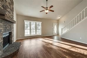 3610 Peakview Dr, Corinth, TX 76210 - unfurnished living room with a fireplace, wood finished floors, baseboards, ceiling fan, and lofted ceiling