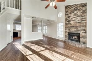 3610 Peakview Dr, Corinth, TX 76210 - unfurnished living room featuring a high ceiling, plenty of natural light, a ceiling fan, wood finished floors, and a fireplace