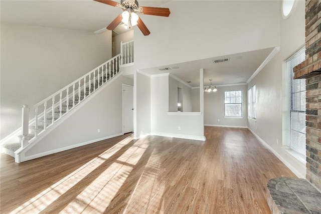 3610 Peakview Dr, Corinth, TX 76210 - unfurnished living room featuring stairs, wood finished floors, a high ceiling, baseboards, and a ceiling fan
