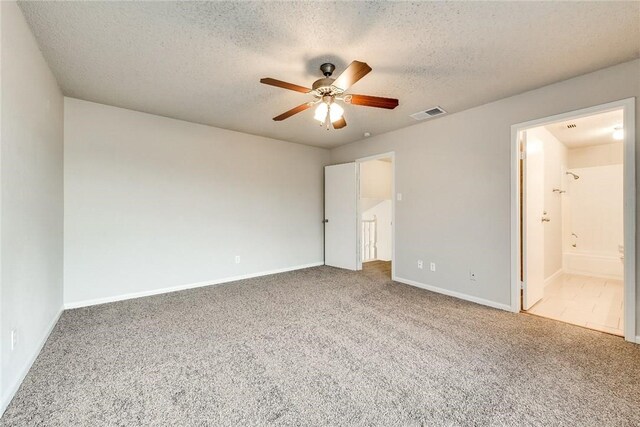 3610 Peakview Dr, Corinth, TX 76210 - unfurnished bedroom with carpet floors, a textured ceiling, baseboards, ceiling fan, and ensuite bath
