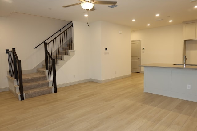 2538 Settlers Pl, Garland, TX 75042 - unfurnished living room with a sink, a ceiling fan, light wood-type flooring, recessed lighting, and stairs